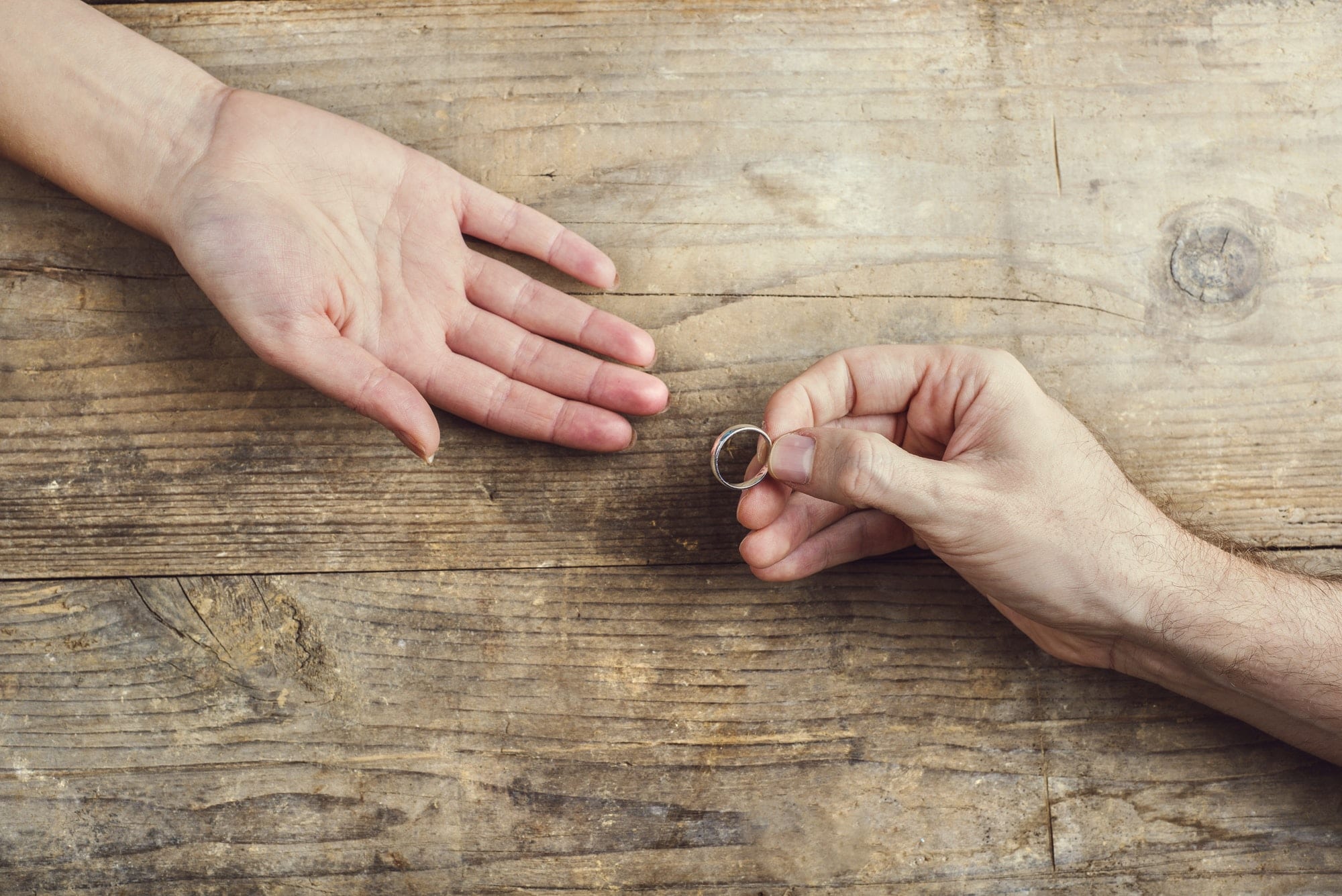 Man offering a ring to a woman.